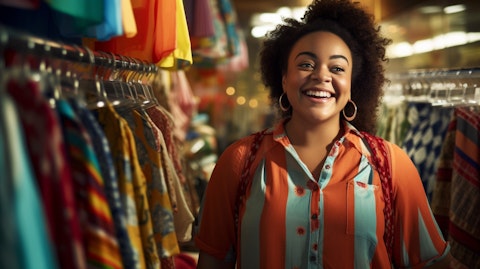 A close-up view of a smiling sales associate at a plus-size apparel store, her face lit up by the colorful items around her.