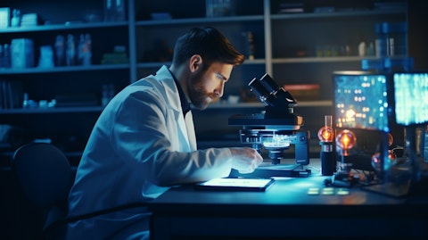 A scientist working with a microscope in a laboratory, using the companys life science platform.