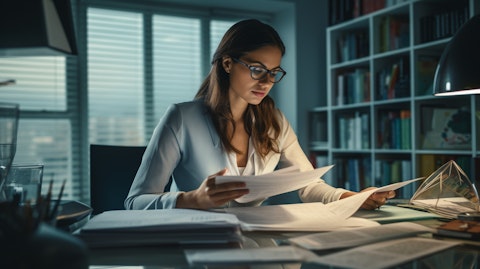 A portfolio manager poring over financial documents in her office, illustrating the company's asset management process.