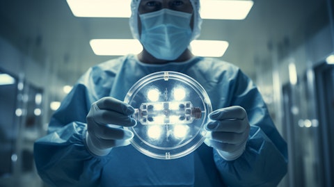 A medical professional holding a HEPZATO Medical Device in an operating room.