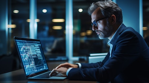 A portfolio manager working diligently on a laptop in a financial trading room to maximize returns for global institutions.