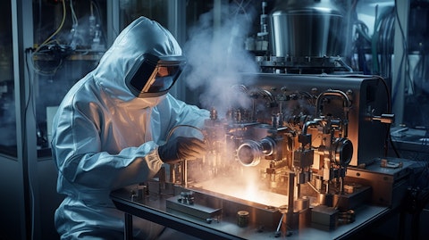 A technician in a clean room environment, operating a diffusion furnace.