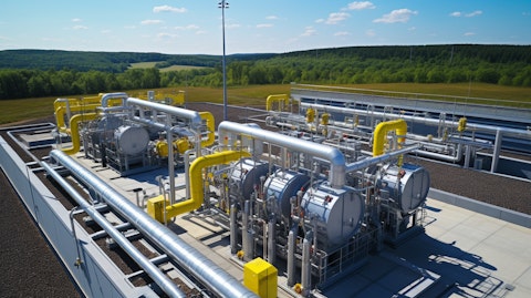 An aerial view of a natural gas compressor station, its engines and piping stretching for miles.