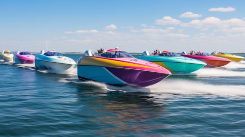 A colorful fleet of recreational fiberglass powerboats in full sail.