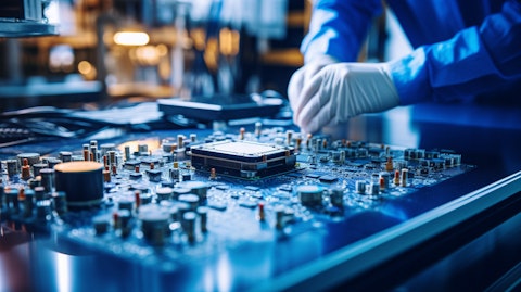 A technician working on a complicated microchip embedded in a circuit board.