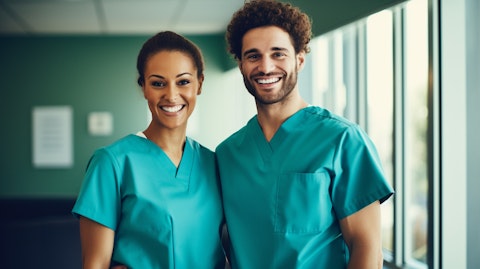 A smiling medical staff in hospital uniforms designed by the company.