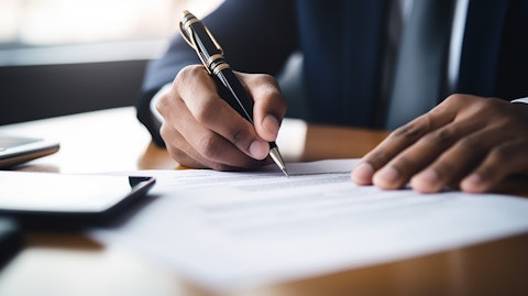 A close-up of a hand holding a pen above a document as if signing an important agreement.