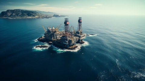 An aerial view of an offshore oil platform against the backdrop of the open sea.
