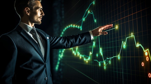 A financial advisor wearing a suit, pointing to a graph demonstrating success and growth in the financial sector.