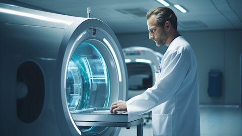 A medical technician checking the Magnetic Resonance Imaging scanner in a hospital.