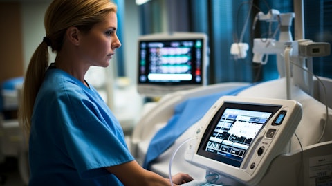 A hospital nurse operating a FREEDOM infusion system, demonstrating its user-friendly interface.