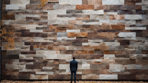 A person in front of an outdoor wall adorned with natural stone products.