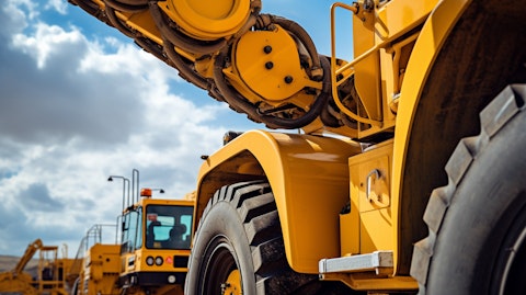 A closeup view of a rough terrain crane in use, showing the strength of the machinery.