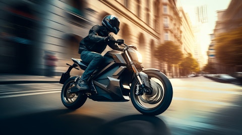 An avid cyclist riding a sleek electric motorcycle on a rugged city street.