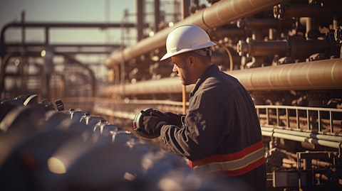 A technician making adjustments to a natural gas pipeline entering a processing facility.