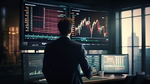 A financial analyst working on a projection screen and researching market trends.