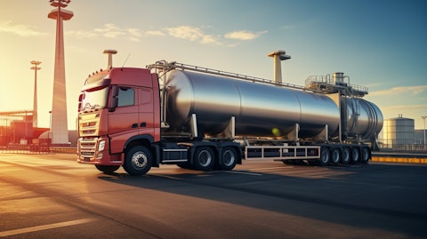 A petrol tanker truck refueling a highway service station, highlighting the fuel distribution arm of the company.