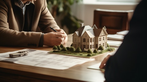 An insurance agent at their desk consulting a customer about property & casualty insurance.