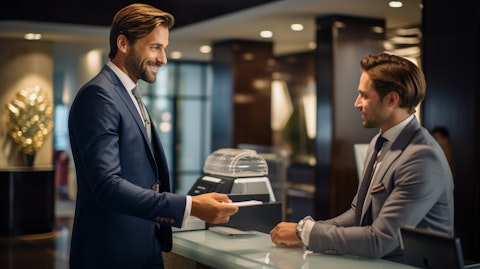 A professional banker wearing a suit and tie, helping a customer deposit money.