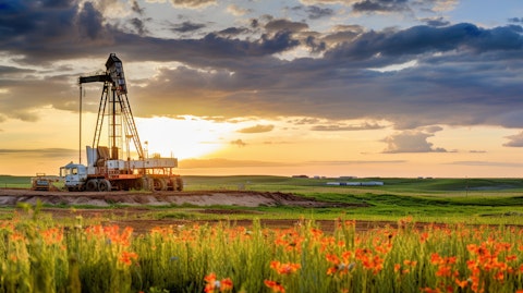 A drilling rig pumping away in the Bakken Formation in the backdrop of a Texas prairie.