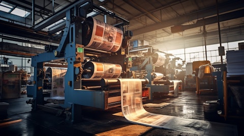 A modern printing press operating in a warehouse, signaling the company's commercial printing services.
