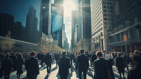 A busy city street with tall buildings and a crowd of people in business attire.