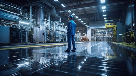 An industrial facility floor with employees walking around PEM fuel cell applications.