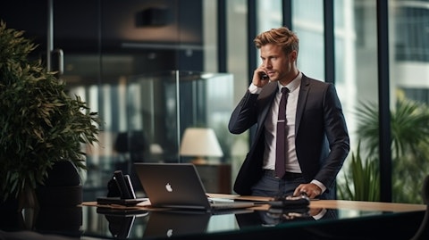 A well-dressed executive talking on the phone in a commercial real estate office.