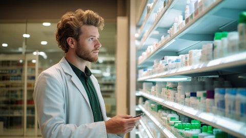 A pharmacist stocking shelves with acne treatments developed by the company.