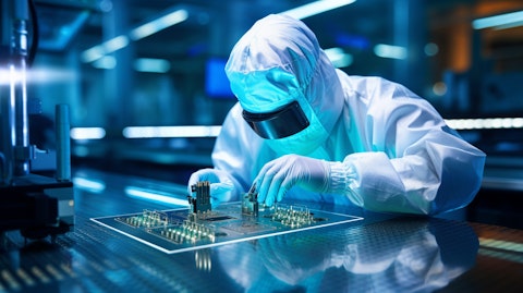 A close up of a technician working on a semiconductor chip in a clean room.