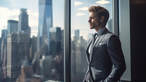 A successful business executive in a suit looking out a window at the financial district.