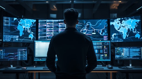 A network engineer solving complicated system issues on a big display monitor.