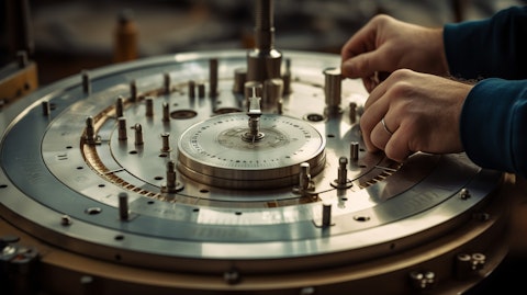 A close up of a large piece of process equipment with a technician adjusting a dial.