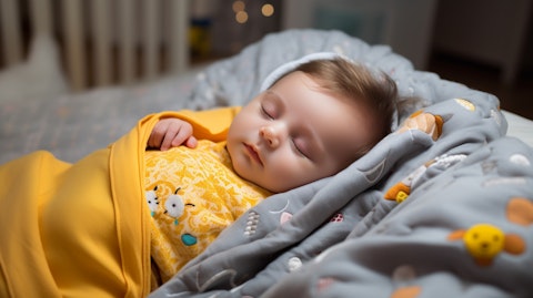 A baby sleeping peacefully with a swaddle blanket and nursery accessories.