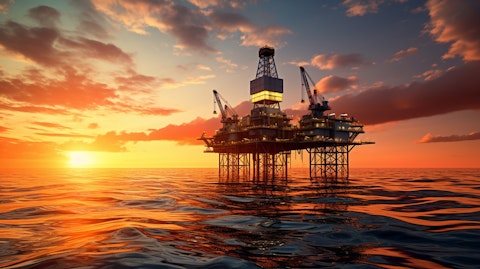 An oil rig in the middle of an ocean reflecting the sunset.