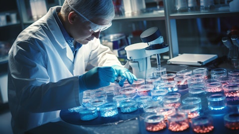 A doctor in a lab coat working on a petri dish containing gene-edited T-cells.