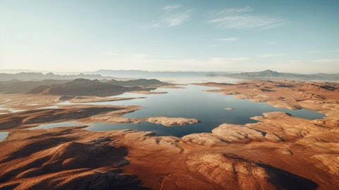 Aerial view of a vast mineral laden lake surrounded by an arid desert.