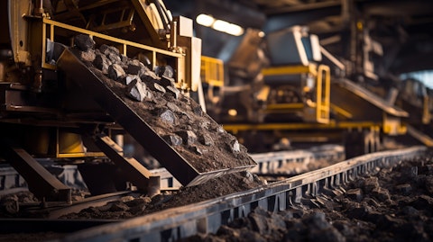 A close-up of a large, metallic machine processing ore and minerals in a mine.