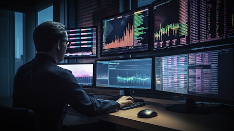 A portfolio manager in front of a computer, assessing financial data in real time.