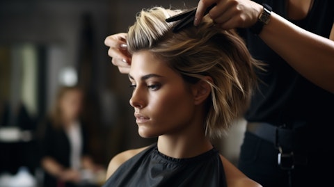 A stylish female hairdresser cutting hair in a salon.