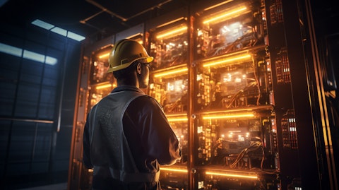 A technician in a hardhat examining a subsea battery system.