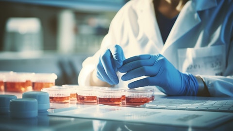 A laboratory technician viewing a microscope slide containing a sample of a blood-based lung test.