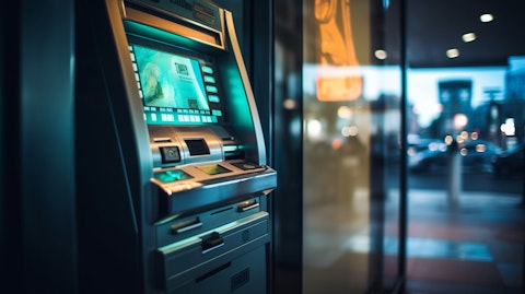 A hand tapping an ATM to withdraw money from a savings account.