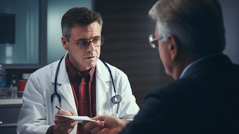 A physician holding a vial of blood and discussing diagnostic options with a patient.
