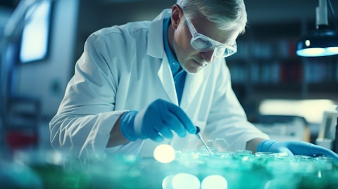 A microbiologist in a lab coat, examining a sample of Gram-positive bacteria.