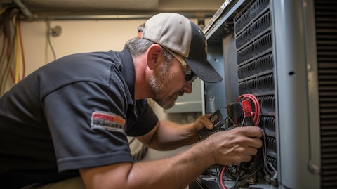 A service technician with a tool belt, inspecting an HVAC unit in a customer's home.