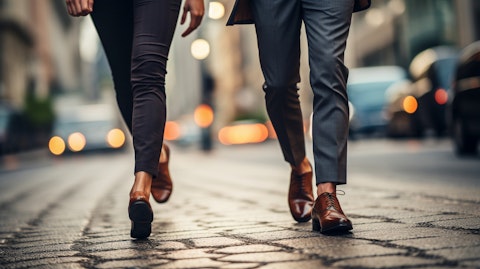 A man and woman walking down the street in stylish leather dress shoes.