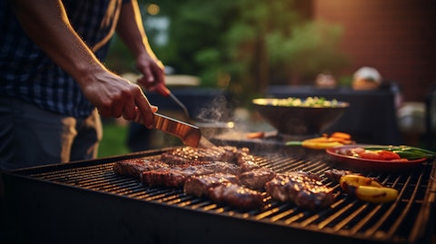 A grillmaster using a wood pellet grill to prepare a meal for a family gathering.