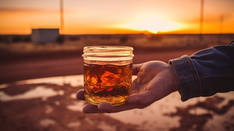 A hand holding a crude oil sample from a well in Permian Basin.