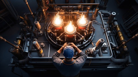 An overhead shot of an employee installing a flame stabilizing device onto an industrial burner body.